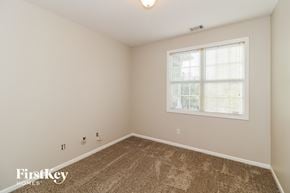 Cumming house for rent - a spacious room with carpet and a window