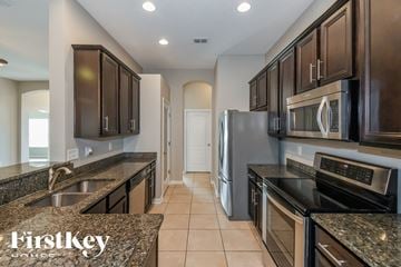 Jacksonville house for rent - a kitchen with granite counter tops and stainless steel appliances