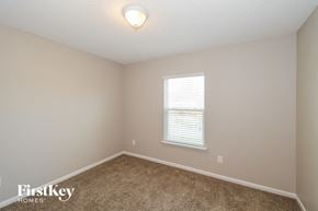 Jacksonville house for rent - a bedroom with beige carpet and a window