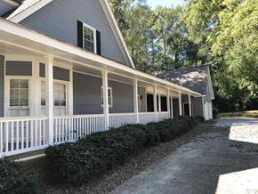 Conyers house for rent - A house with a grey exterior and white trim.