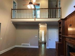 Conyers house for rent - A living room with a balcony and a fireplace.