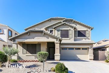 Goodyear house for rent - a house with a garage and a driveway in front of it