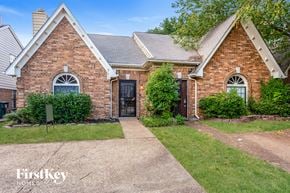 Memphis house for rent - a brick house with a sidewalk and grass in front of it