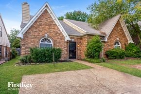 Memphis house for rent - a small brick house with a driveway and grass