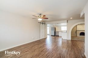 Phoenix house for rent - a living room with hardwood floors and a ceiling fan