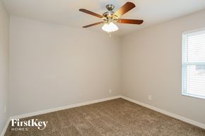 Phoenix house for rent - the bedroom has a ceiling fan and a carpet