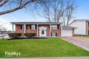 Florissant house for rent - a brick house with a white front door and a lawn