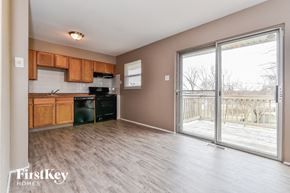 Florissant house for rent - an empty kitchen with a sliding glass door to a deck