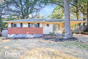 Memphis house for rent - a small brick house with a tree in front of it