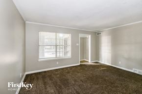 Memphis house for rent - an empty living room with carpet and a window