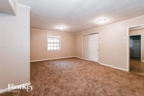 Memphis house for rent - a master bedroom with carpet and a door to a closet