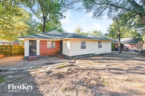 Memphis house for rent - a small white house with a yard and some trees