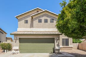 Surprise house for rent - A house with a green garage door is for sale.