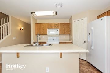 Surprise house for rent - A kitchen with a white counter top and wooden cabinets.