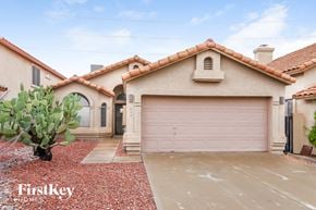Phoenix house for rent - A house with a red tile roof and a garage door.