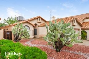 Phoenix house for rent - A house with a red roof and a cactus in front.