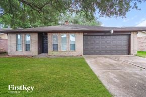 Houston house for rent - A house with a garage door and a driveway.