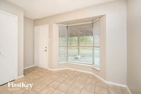 Houston house for rent - A room with a window covered by blinds and a door.