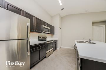 Palm Bay house for rent - a modern kitchen with stainless steel appliances and black cabinets