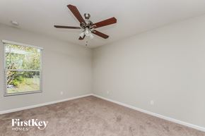 Palm Bay house for rent - the master bedroom has a ceiling fan and a beige carpet
