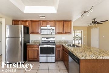 Phoenix house for rent - A kitchen with a refrigerator, stove, and oven.