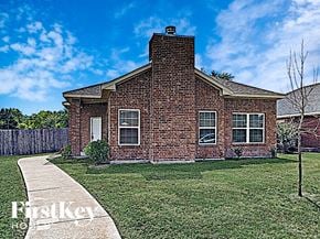 Desoto house for rent - A brick house with a white door and windows is for sale.