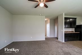 Houston house for rent - A room with a ceiling fan and a carpeted floor.