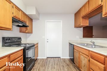 Glendale house for rent - a kitchen with wood flooring and wooden cabinets
