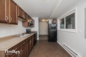 Markham house for rent - a kitchen with wooden cabinets and stainless steel appliances and a window