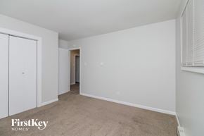 Markham house for rent - a bedroom with white walls and carpet and a door to a closet