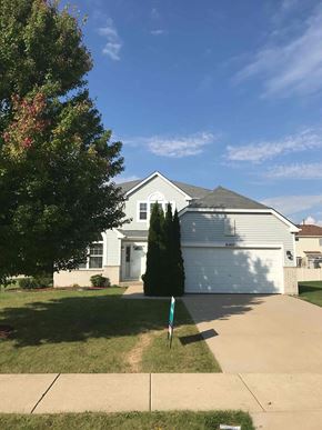 Crest Hill house for rent - a white house with a blue garage door and a lawn