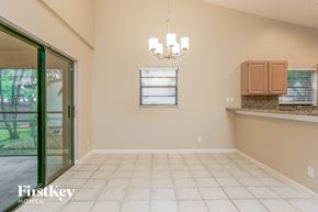 Fort Lauderdale house for rent - an empty dining room with a door to the backyard