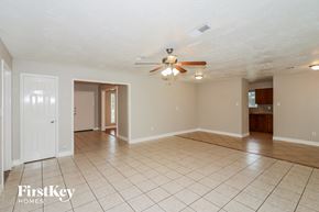Houston house for rent - a spacious living room with tile flooring and a ceiling fan