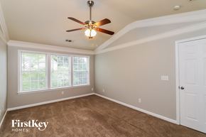 Kennesaw house for rent - a bedroom with carpet and a ceiling fan