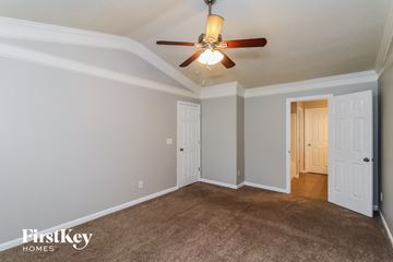 Kennesaw house for rent - a living room with a ceiling fan and a carpet