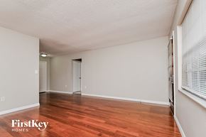 Lakeland house for rent - a spacious living room with wood flooring and white walls