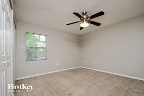 Lakeland house for rent - the master bedroom has a ceiling fan and a carpeted floor