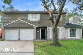 Houston house for rent - A house with a tree in front of it.