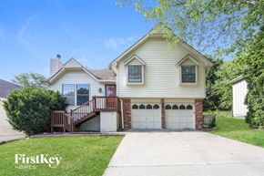 Independence house for rent - a white house with a driveway and a garage door