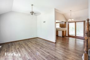 Independence house for rent - an empty living room with wood floors and white walls