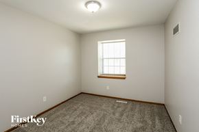 Independence house for rent - a bedroom with white walls and a window and a carpet