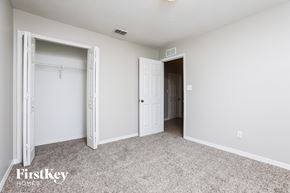 Winter Garden house for rent - a bedroom with white walls and carpet and a door to a closet