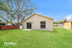 Winter Garden house for rent - a small white house with a grass yard and a fence