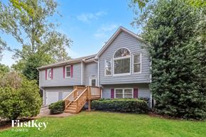 Douglasville house for rent - the front of a house with a yard and a deck