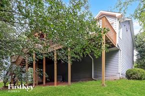Douglasville house for rent - a small white house with a deck and trees