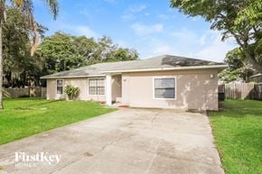 Deltona house for rent - A house with a driveway in front of it.