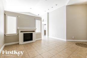 Homestead house for rent - a living room with a fireplace and a tiled floor