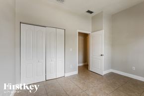 Homestead house for rent - a master bedroom with two closets and a tiled floor
