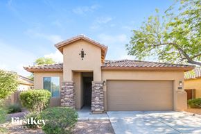Surprise house for rent - a house with a driveway and a garage door