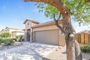 Surprise house for rent - a tree in front of a house with a garage door